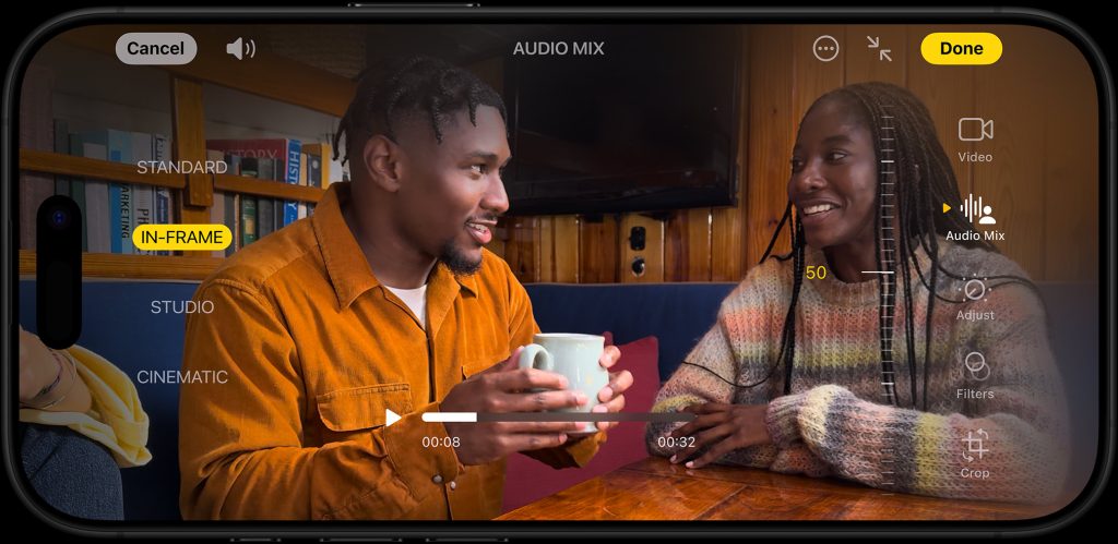 A horizontal shot of two people talking while enjoying coffee and looking at one another, seemingly in deep conversation. The area around the image showcases the video recording options including the audio adjustment options on the new iPhone16. 