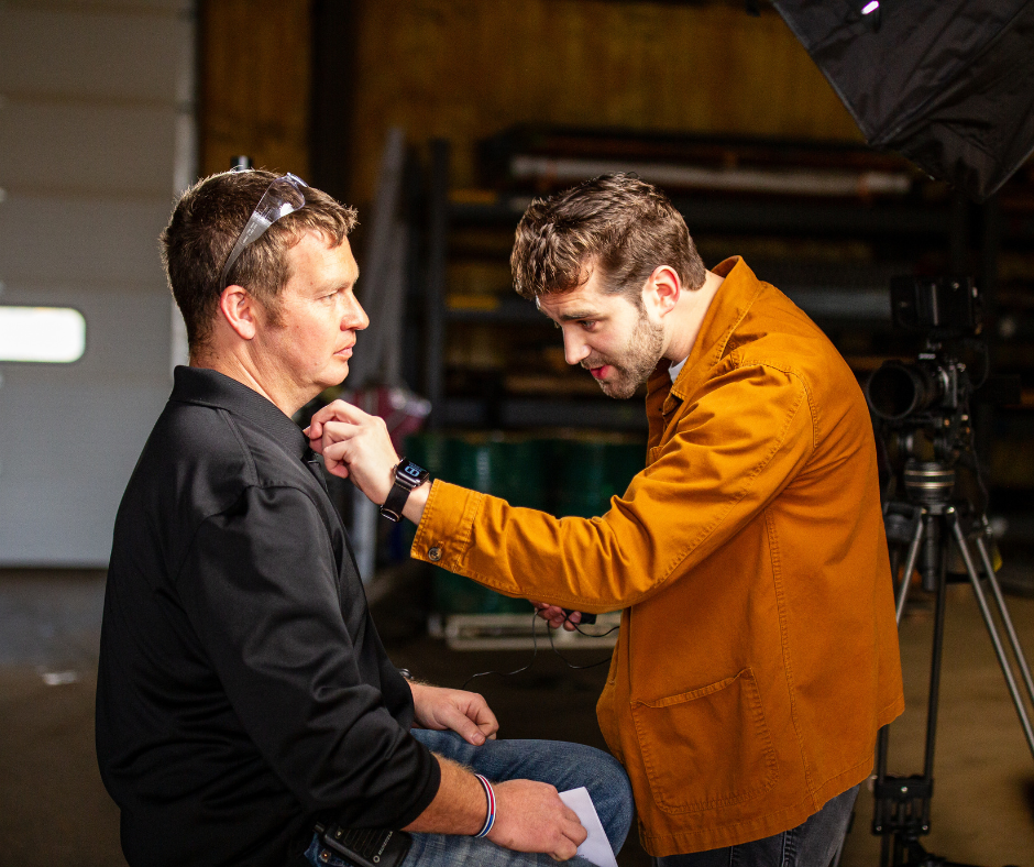 Video Production Austin adjusting a microphone on Shay Schupan.